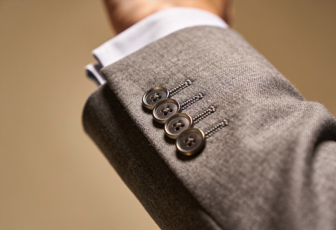 A working cuff with pick-stitching — small proof of a garment made properly.